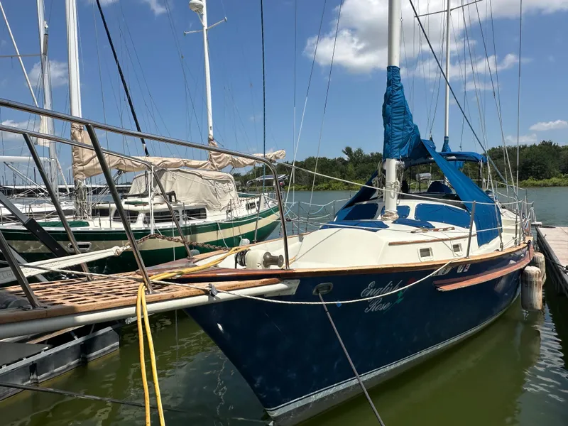 Slide: The Image of 1982 Irwin 46 sailboat docked, blue hull, white deck, blue covers, sunny day. - 8