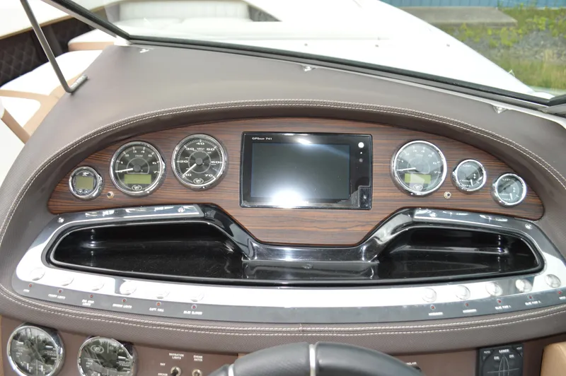 Slide: The Image of Dashboard of a 2016 Cobalt 302 boat with gauges and a central display. - 13