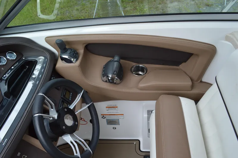 Slide: The Image of Interior of 2016 Cobalt 302 boat showing steering wheel and controls. - 14