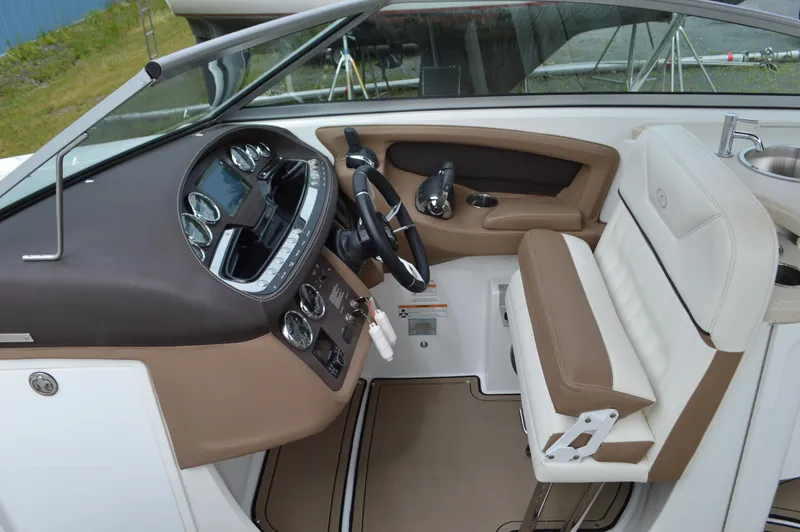 Slide: The Image of Interior of a 2016 Cobalt 302 boat with beige and white seating, modern dashboard. - 15