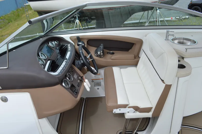 Slide: The Image of Interior of a 2016 Cobalt 302 boat, featuring a sleek dashboard and comfortable seating. - 16