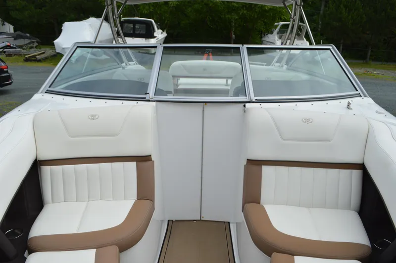 Slide: The Image of 2016 Cobalt 302 boat interior with white and brown seating, open bow design. - 23