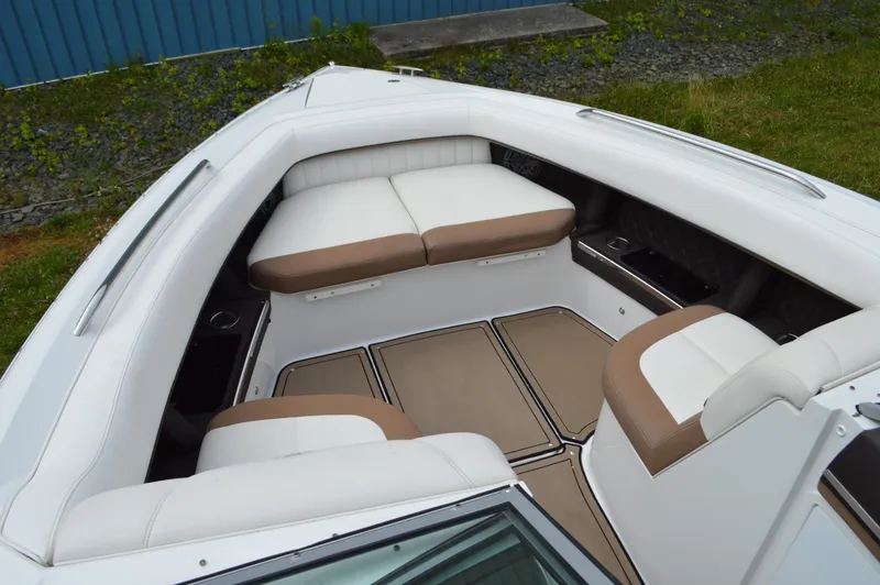 Slide: The Image of 2016 Cobalt 302 boat interior with white and tan seating, spacious layout. - 29