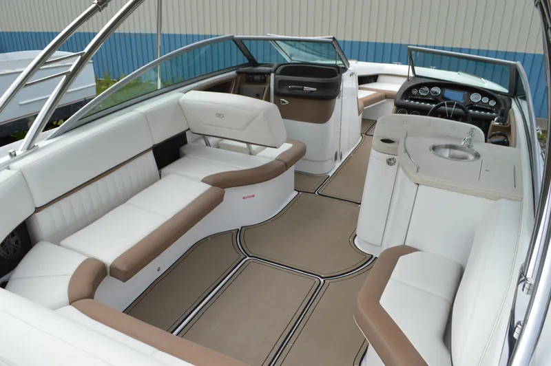 Slide: The Image of 2016 Cobalt 302 boat interior with white and tan seating, sleek dashboard, and modern amenities. - 3