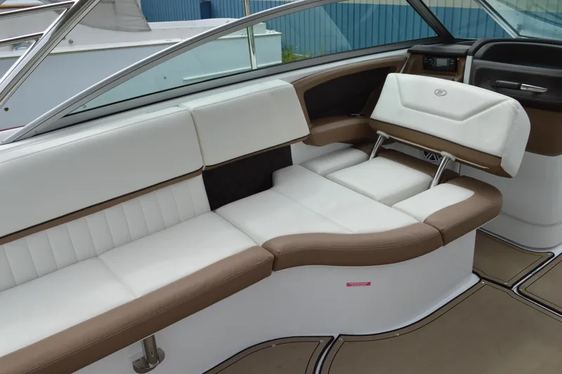 Slide: The Image of Interior of a 2016 Cobalt 302 boat with white and brown seating. - 31