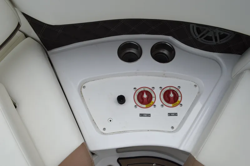 Slide: The Image of Control panel of a 2016 Cobalt 302 boat with switches and cup holders. - 35