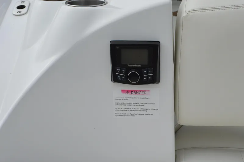 Slide: The Image of 2016 Cobalt 302 boat interior with control panel and warning label. - 36