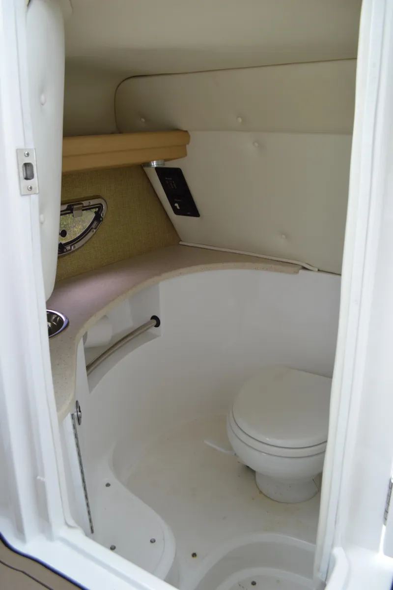 Slide: The Image of 2016 Cobalt 302 boat interior bathroom with toilet and sink. - 38