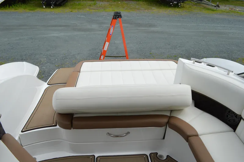 Slide: The Image of 2016 Cobalt 302 boat interior with white and brown seating, outdoor setting. - 41