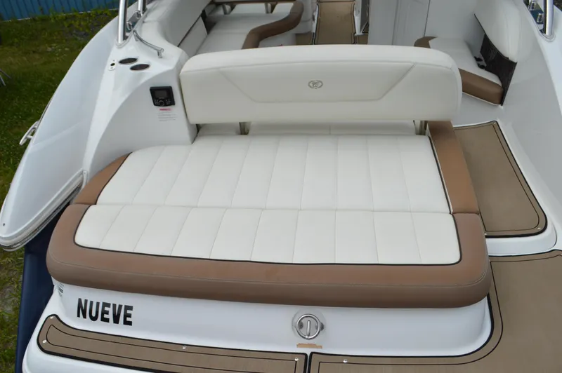 Slide: The Image of 2016 Cobalt 302 boat with white and brown seating, rear view. - 42