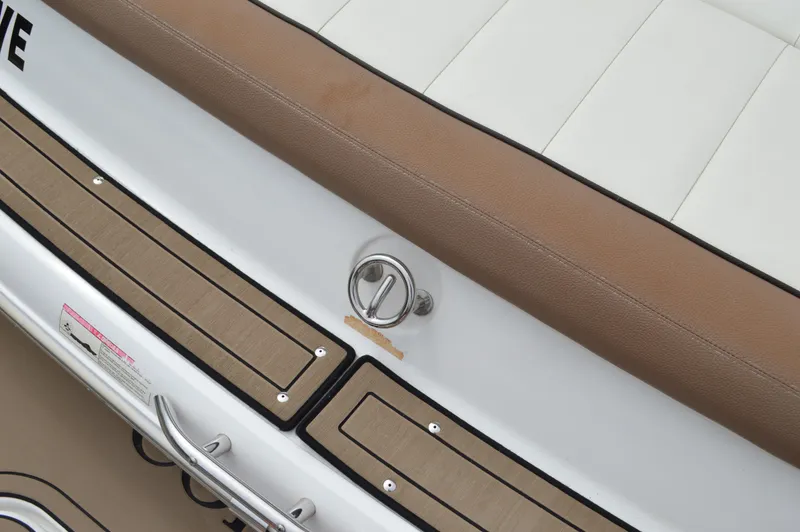 Slide: The Image of 2016 Cobalt 302 boat interior with tan and white seating, stainless steel details. - 45