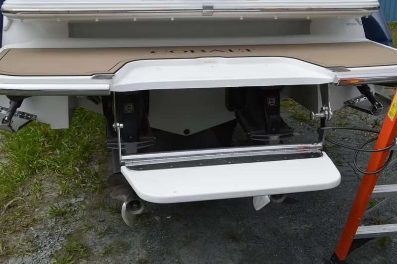 Slide: The Image of 2016 Cobalt 302 boat stern with swim platform and outboard motors. - 48