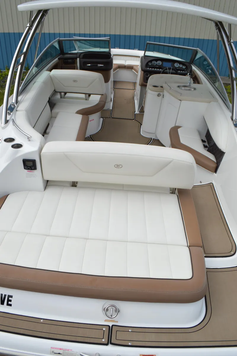 Slide: The Image of 2016 Cobalt 302 boat interior with white and brown seating, sleek design. - 49