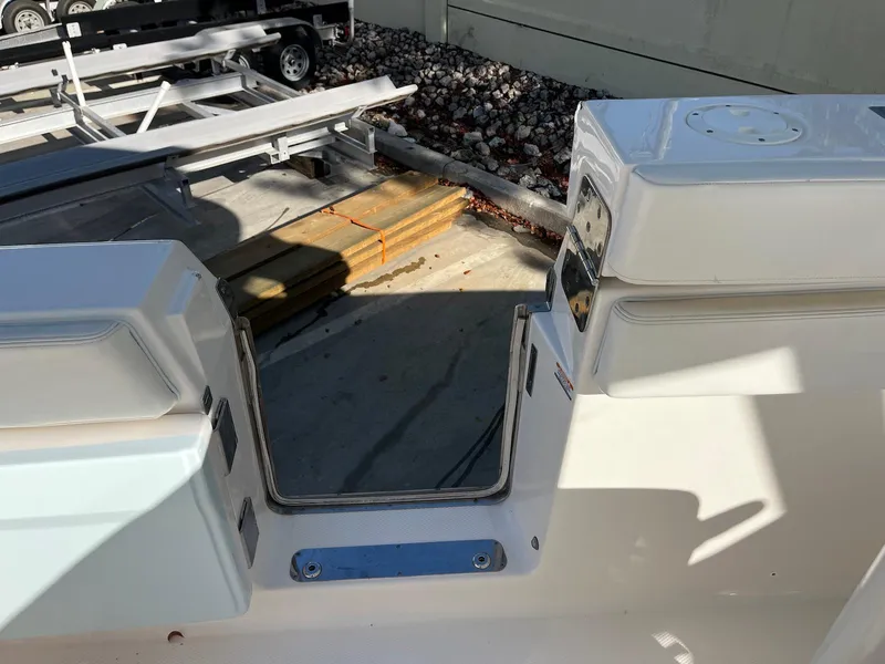 Slide: The Image of 2021 Robalo R272 Center Console boat entryway, featuring sleek white design and sturdy construction. - 12