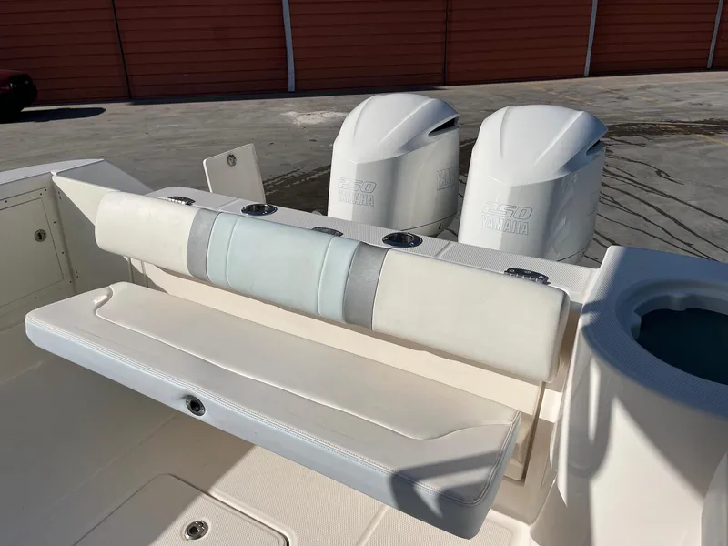 Slide: The Image of 2021 Robalo R272 Center Console boat with dual engines and foldable seating. - 14