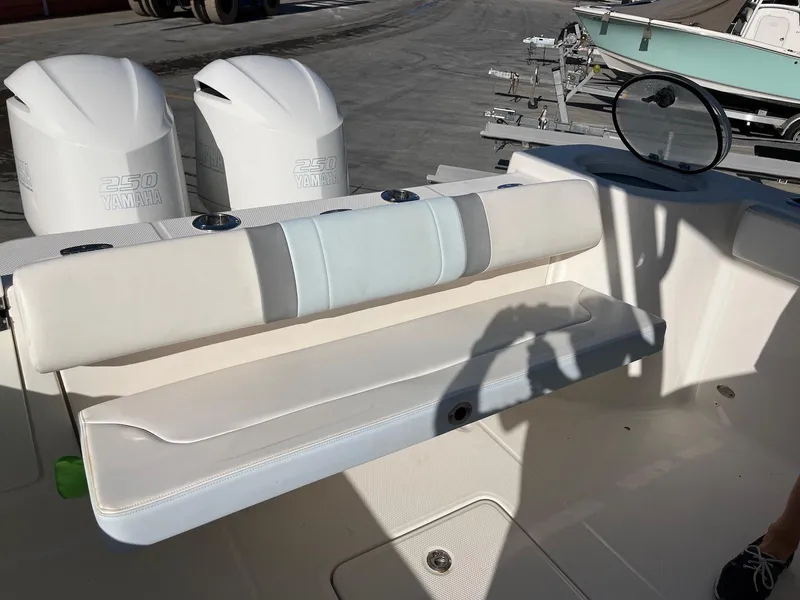 Slide: The Image of 2021 Robalo R272 Center Console boat with Yamaha engines and seating area. - 15