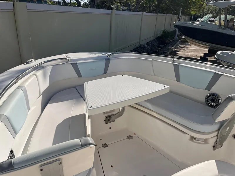 Slide: The Image of 2021 Robalo R272 Center Console boat with spacious seating and table in the bow area. - 17