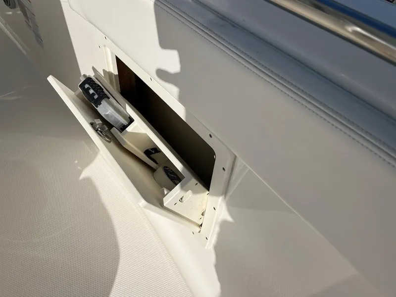 Slide: The Image of 2021 Robalo R272 Center Console storage compartment with open hatch and visible contents. - 18
