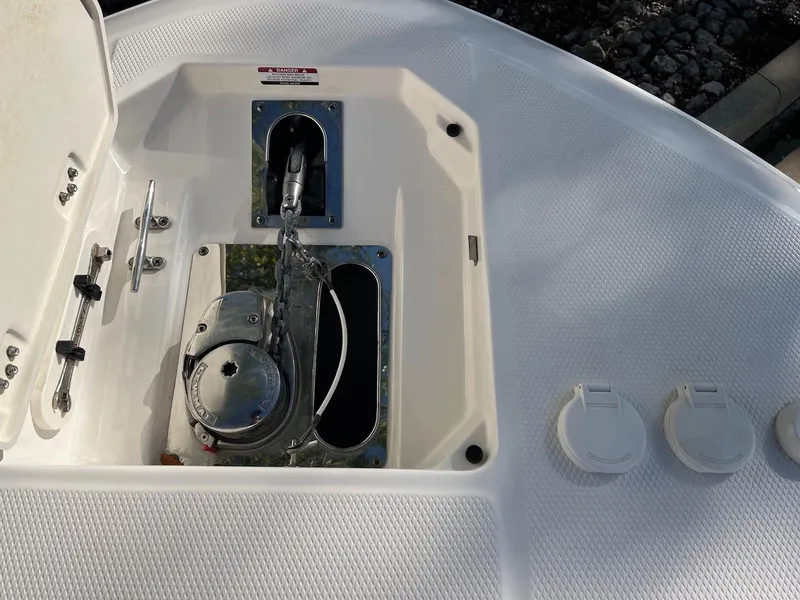 Slide: The Image of 2021 Robalo R272 Center Console anchor compartment with winch and storage. - 19