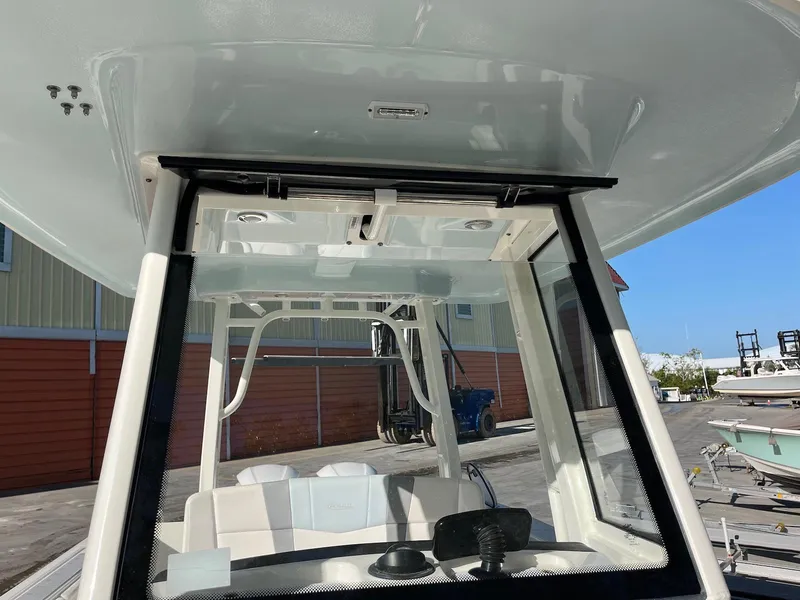 Slide: The Image of 2021 Robalo R272 Center Console boat, featuring a sleek helm and modern design. - 20