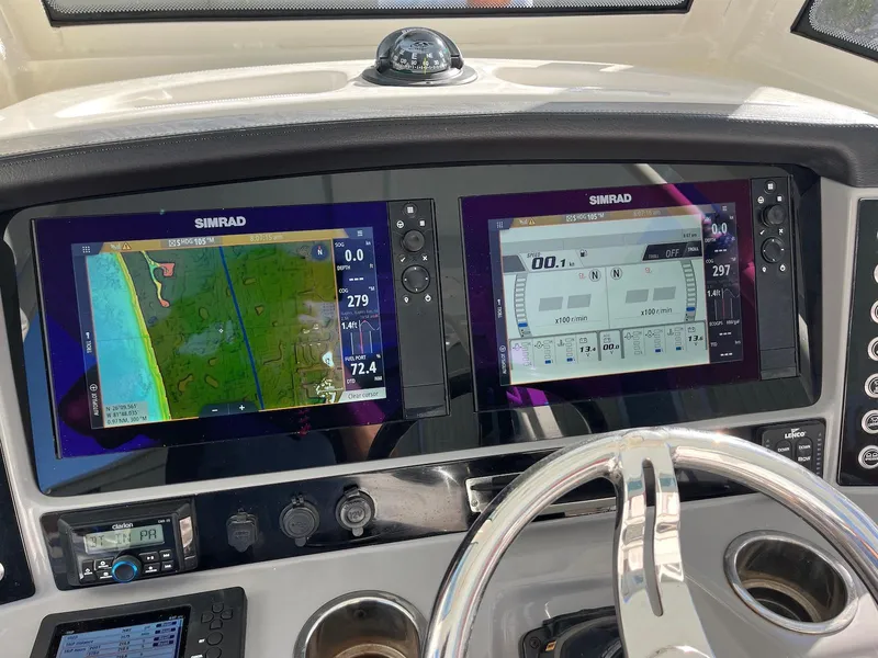 Slide: The Image of 2021 Robalo R272 Center Console with dual Simrad navigation displays and steering wheel. - 22