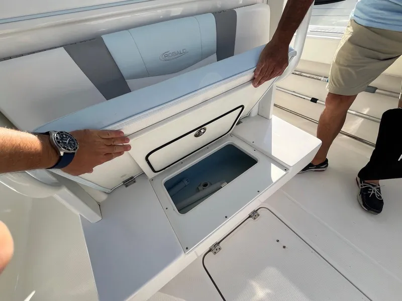 Slide: The Image of 2021 Robalo R272 Center Console boat with open storage compartment. - 24