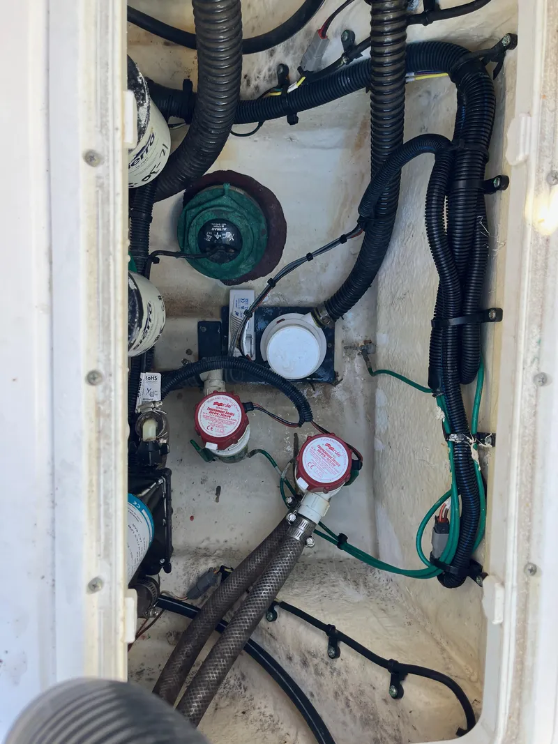 Slide: The Image of 2021 Robalo R272 Center Console boat wiring and components in the engine compartment. - 8