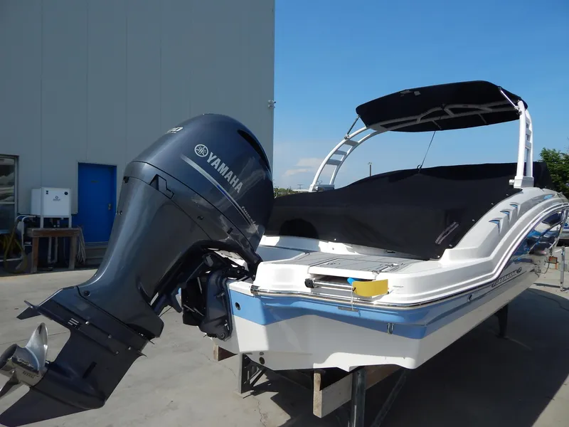 Slide: The Image of 2022 Chaparral 23 SSi OB boat with Yamaha outboard motor, docked outdoors. - 10