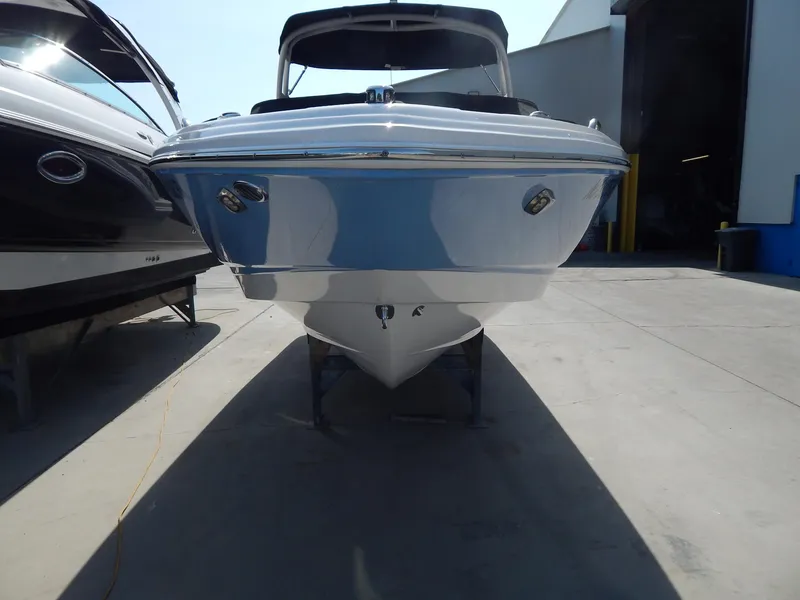 Slide: The Image of 2022 Chaparral 23 SSi OB boat, front view, parked in a marina. - 20