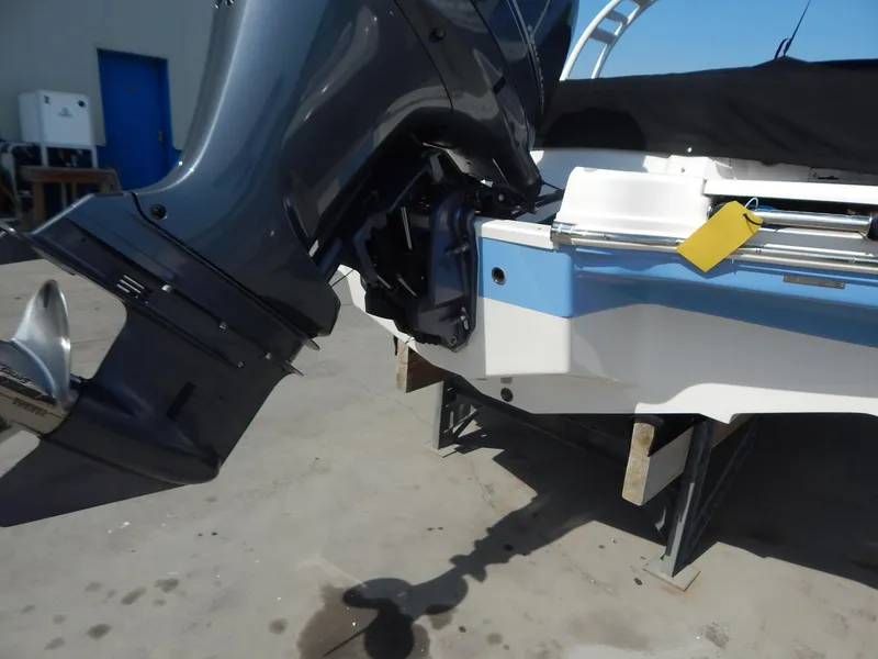 Slide: The Image of 2022 Chaparral 23 SSi OB boat with outboard motor, docked on a stand. - 26