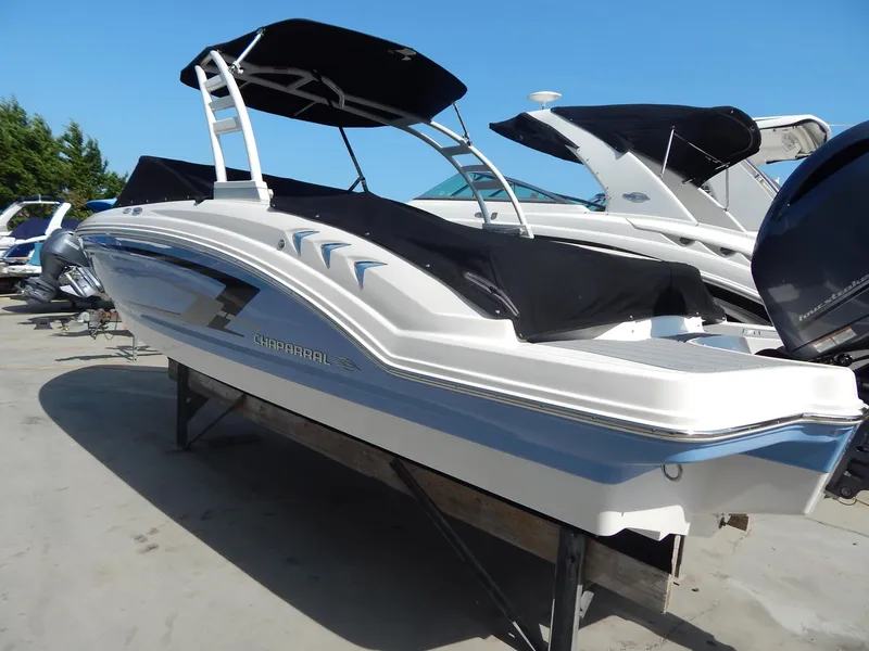 Slide: The Image of 2022 Chaparral 23 SSi OB boat with sleek design and black canopy. - 29