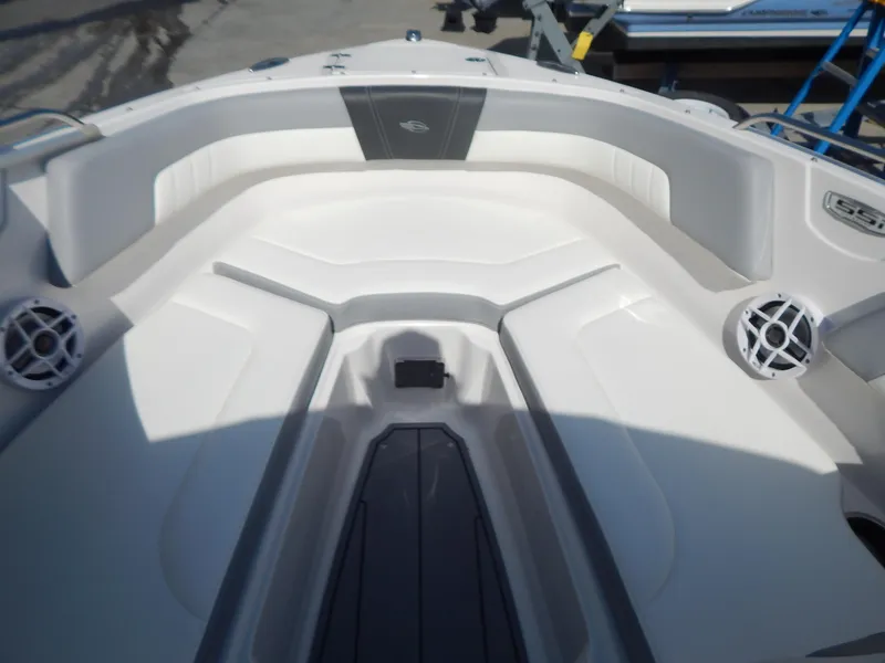 Slide: The Image of 2022 Chaparral 23 SSi OB boat interior with white seating and speaker system. - 39