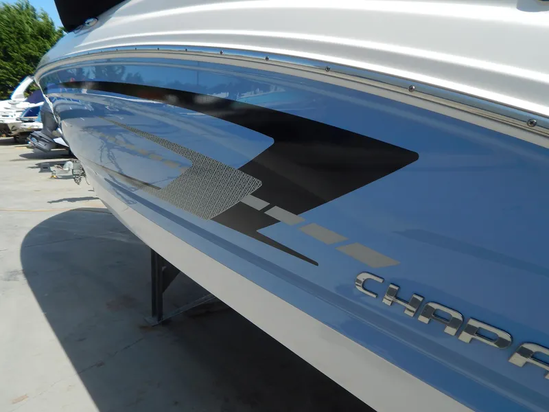 Slide: The Image of 2022 Chaparral 23 SSi OB boat side view with sleek design and graphics. - 4