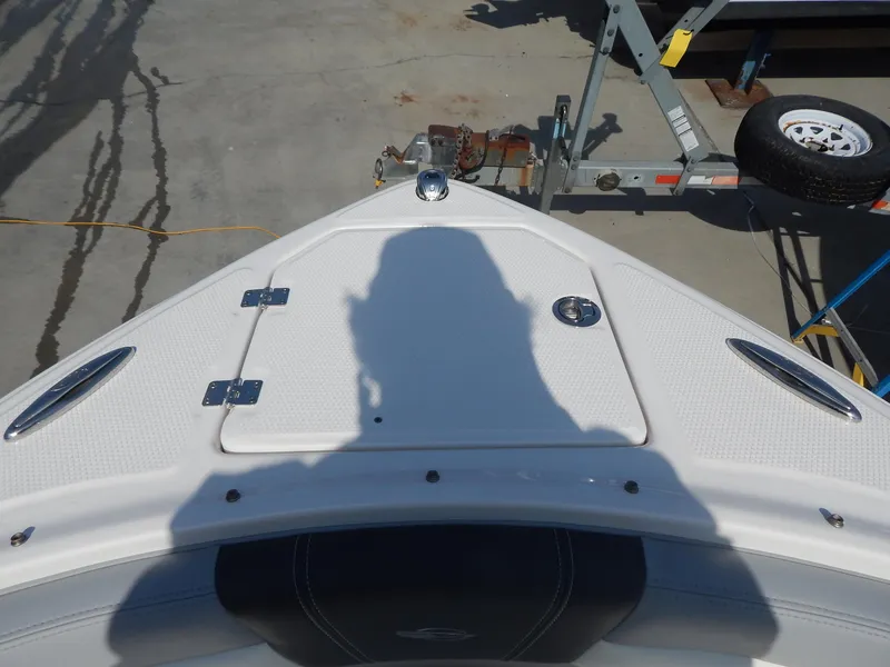 Slide: The Image of 2022 Chaparral 23 SSi OB boat bow with shadow on deck, trailer visible. - 40