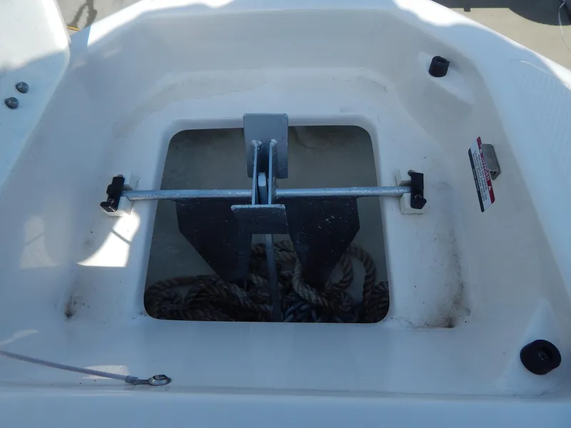Slide: The Image of Anchor compartment of 2022 Chaparral 23 SSi OB boat with rope storage. - 41