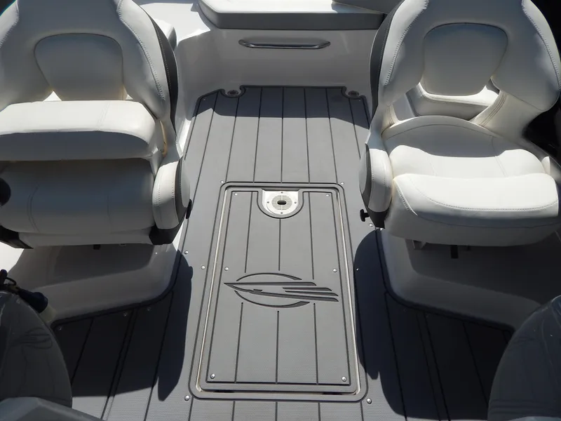 Slide: The Image of 2022 Chaparral 23 SSi OB boat interior with gray flooring and white seating. - 43
