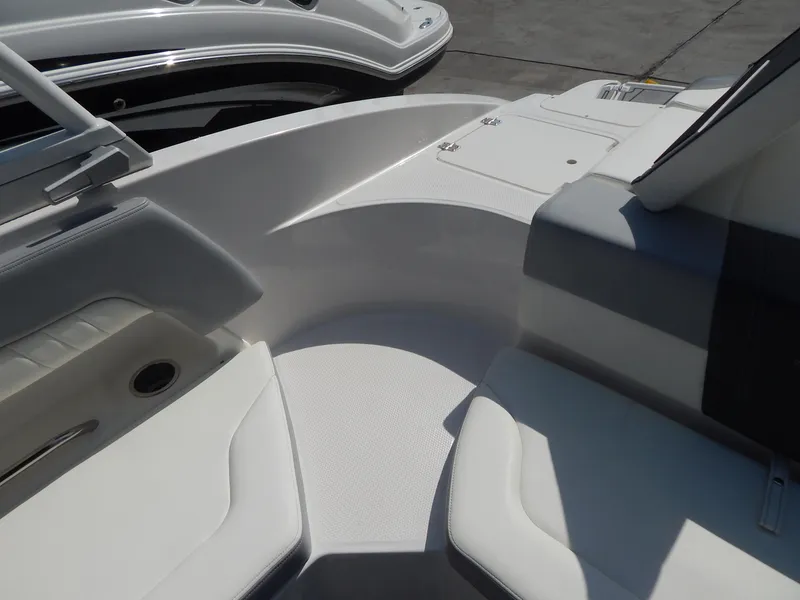 Slide: The Image of 2022 Chaparral 23 SSi OB boat interior with white seating and sleek design. - 44