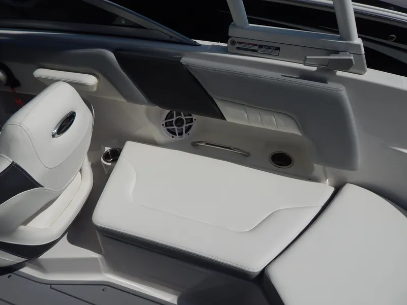 Slide: The Image of 2022 Chaparral 23 SSi OB boat interior with white seating and speaker. - 47