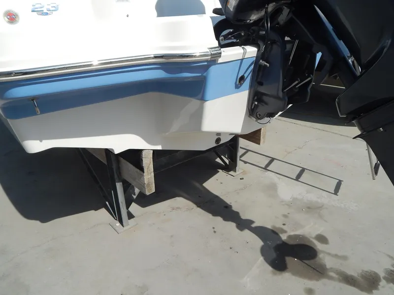 Slide: The Image of 2022 Chaparral 23 SSi OB boat stern with outboard motor on a stand. - 5