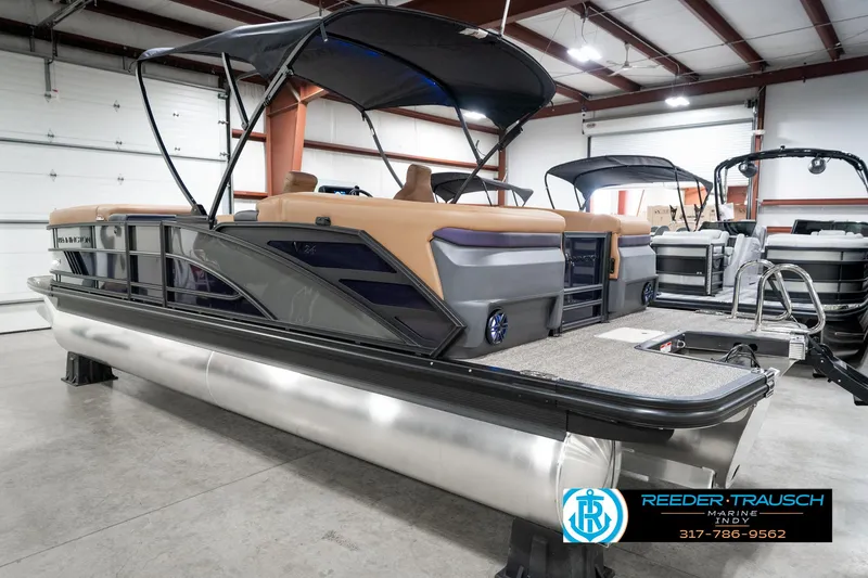 Slide: The Image of 2025 Bennington 24 MSB pontoon boat in showroom, featuring sleek design and modern amenities. - 10