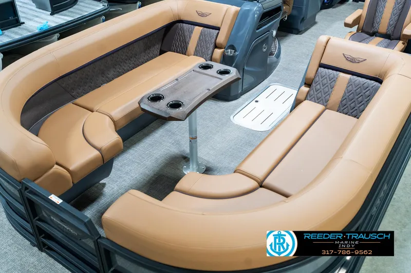 Slide: The Image of Luxurious interior of 2025 Bennington 24 MSB pontoon boat with tan seating and table. - 12