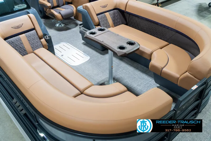 Slide: The Image of 2025 Bennington 24 MSB pontoon boat interior with tan seating and table. - 13