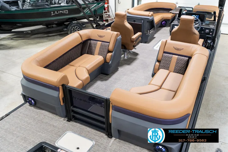 Slide: The Image of 2025 Bennington 24 MSB pontoon boat with luxurious tan seating and modern interior design. - 14