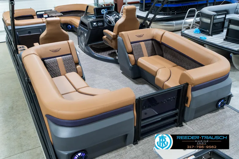 Slide: The Image of 2025 Bennington 24 MSB pontoon boat with luxurious tan seating and modern dashboard. - 15