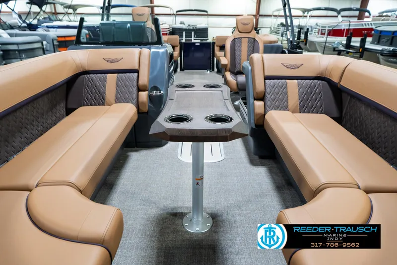 Slide: The Image of Luxurious interior of 2025 Bennington 24 MSB pontoon boat with tan seating and central table. - 16