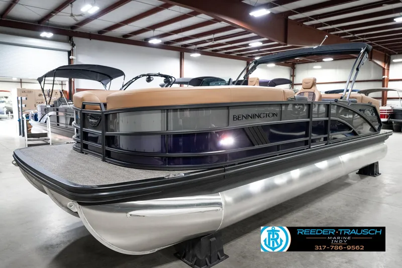 Slide: The Image of 2025 Bennington 24 MSB pontoon boat in showroom, featuring sleek design and modern amenities. - 2