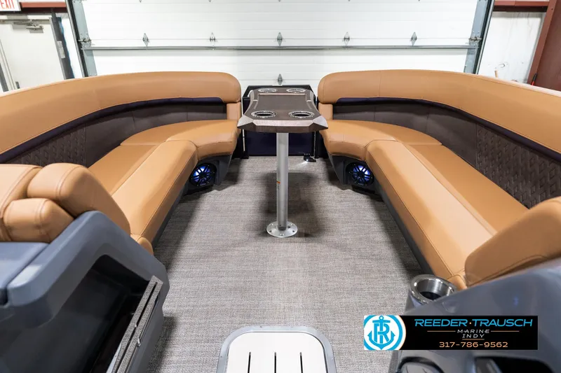 Slide: The Image of 2025 Bennington 24 MSB boat interior with tan seating and central table. - 21