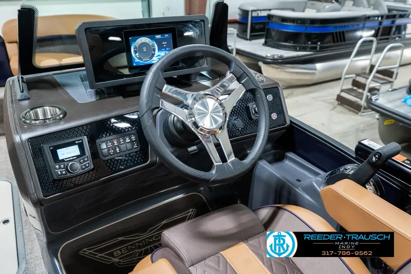 Slide: The Image of 2025 Bennington 24 MSB boat dashboard with steering wheel and digital display. - 31