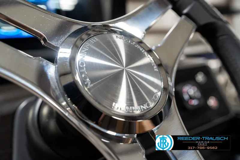 Slide: The Image of Steering wheel of 2025 Bennington 24 MSB boat, featuring sleek metallic design. - 32