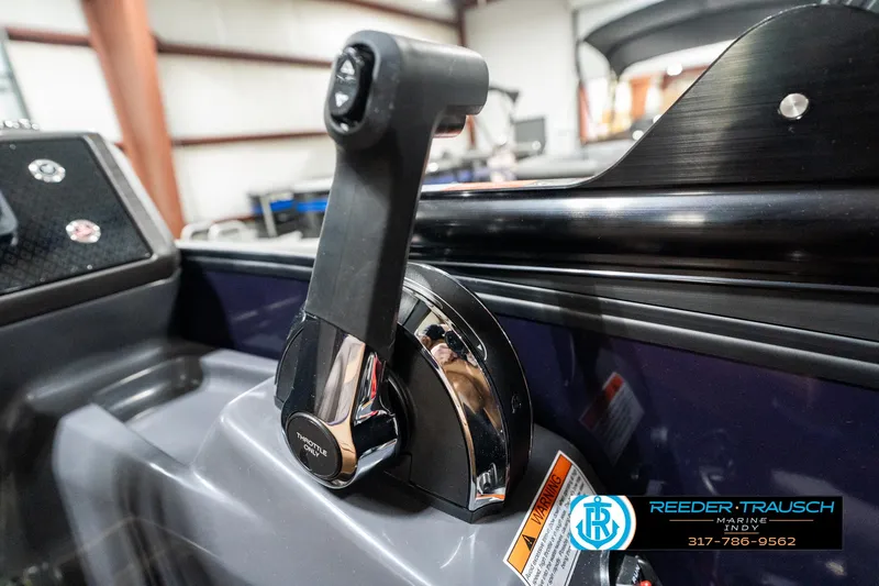 Slide: The Image of 2025 Bennington 24 MSB boat throttle control in a showroom setting. - 37